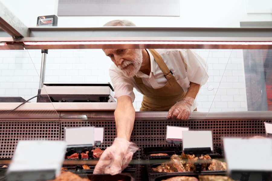 Retail butcher counter with fresh cuts of meat